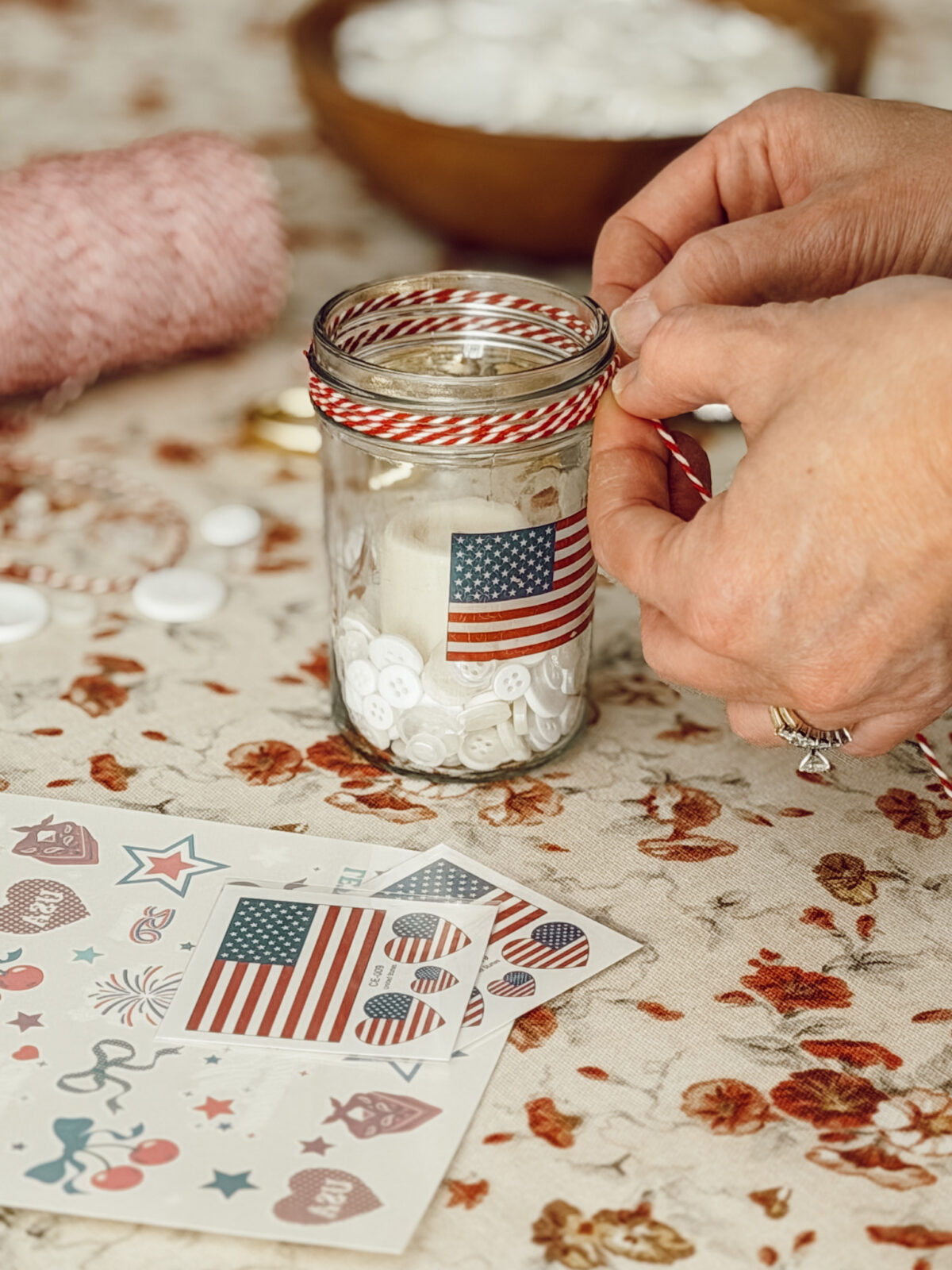 Tie red and white kitchen twine to the top of the mason jar DIY votive candle.