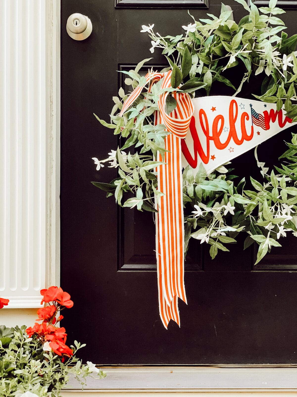 Weekly Wednesday Wish List #259 Eleanor Rose Home front door with a patriotic wreath and red geraniums.