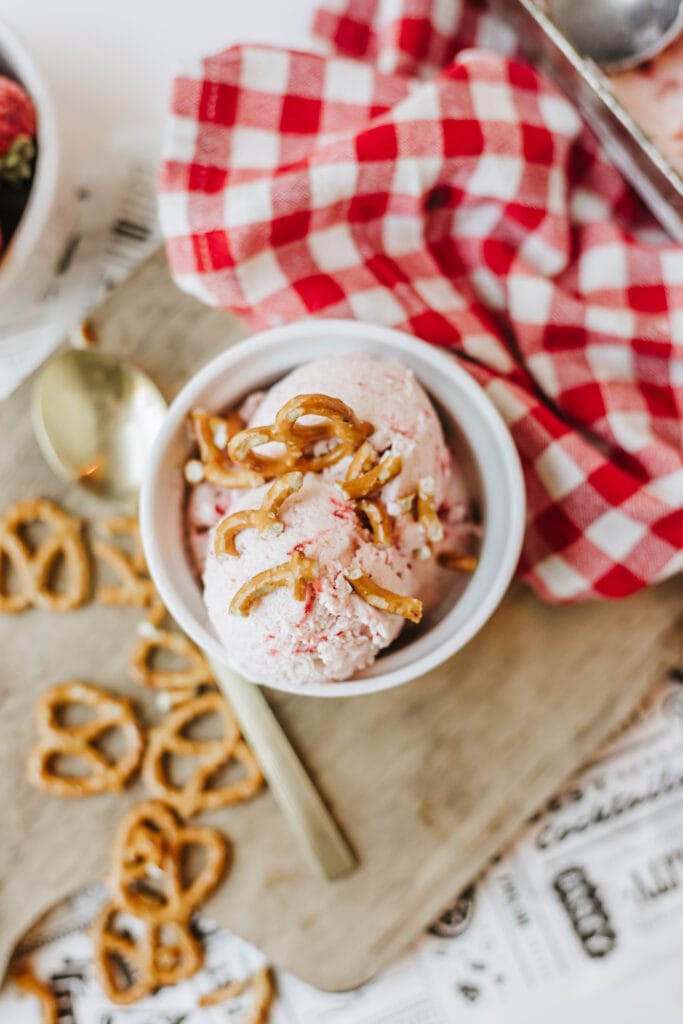 Bowl of berry ice cream topped with crushed pretzels for a sweet and salty crunch.