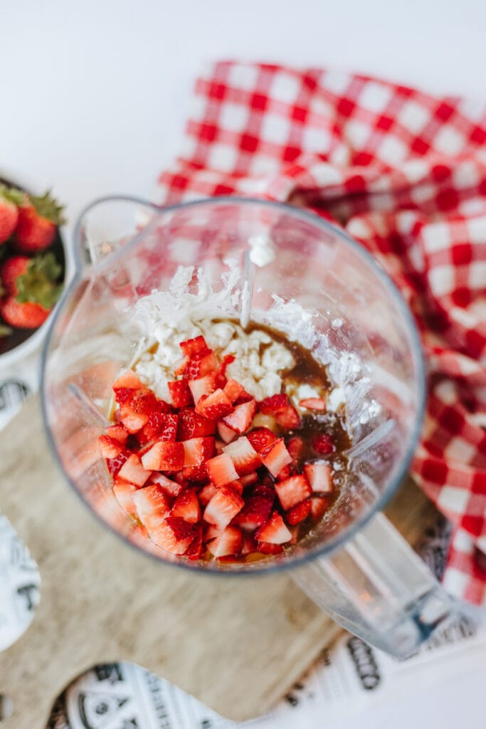 Chopped fresh strawberries in blender to make a no churn ice cream.