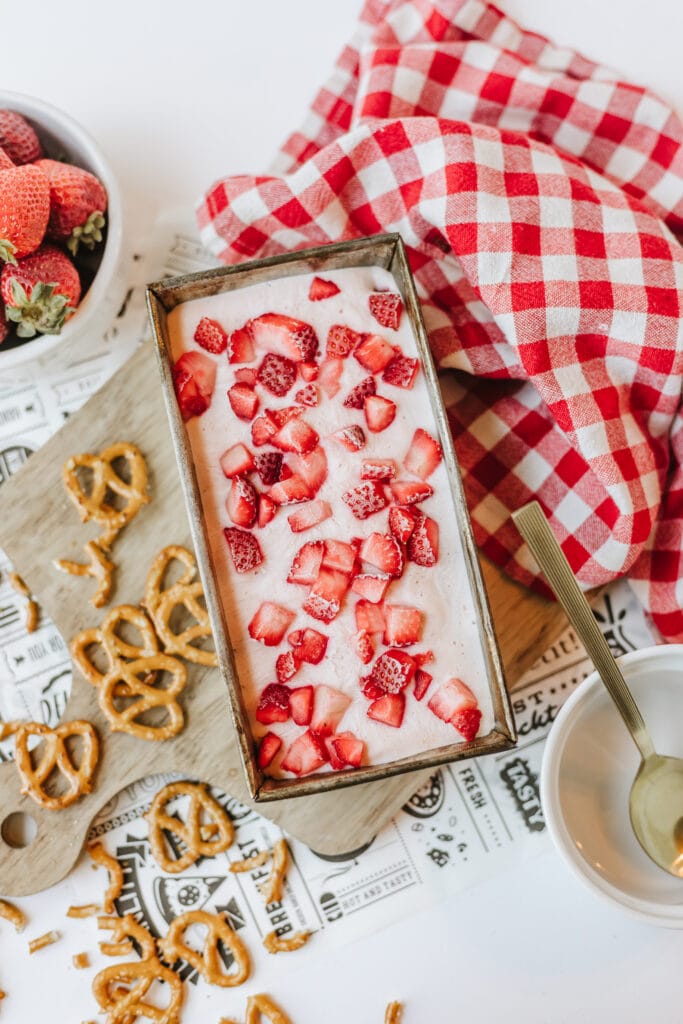 Cottage cheese ice cream made with fresh strawberries and honey in a freezer-safe container.