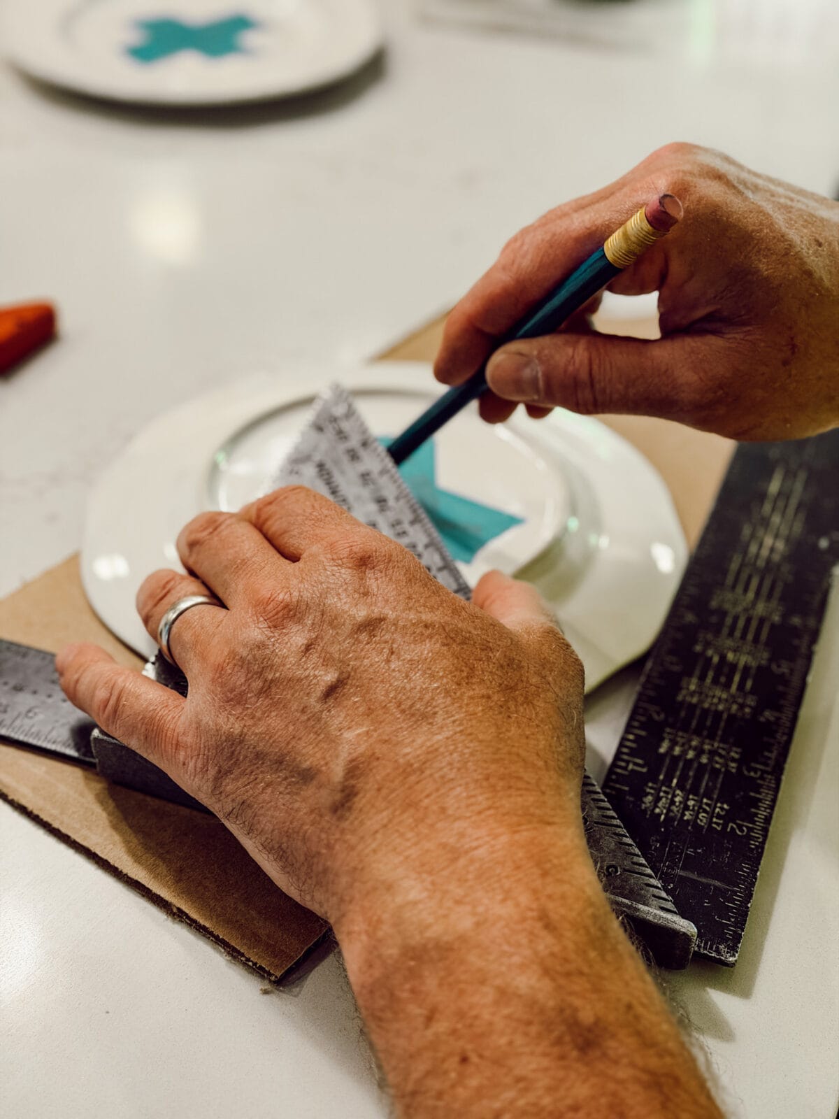 Using a ruler or measuring tape mark the center of the plate before drilling a hole for the tiered tray hardware.