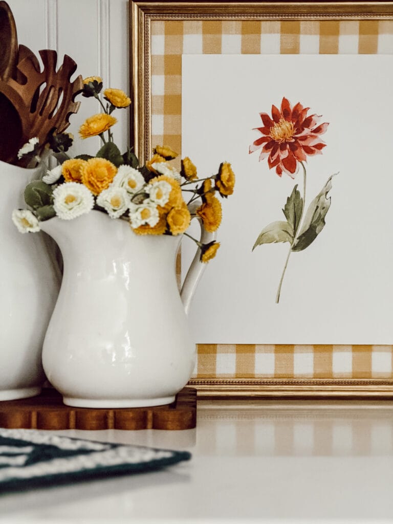 Printable wall art summer season collection framed and styled on kitchen counter.