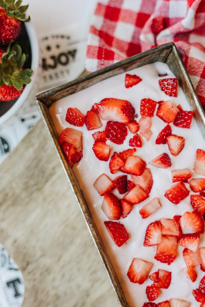Strawberry cottage cheese ice cream in a metal loaf pan ready to go into the freezer to freeze.