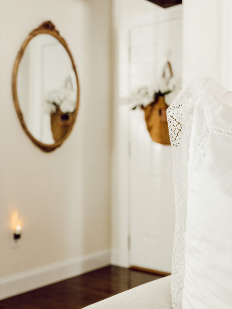 Woven rattan bag, white hydrangeas, and ribbon used to make a cozy summer decoration for the door.