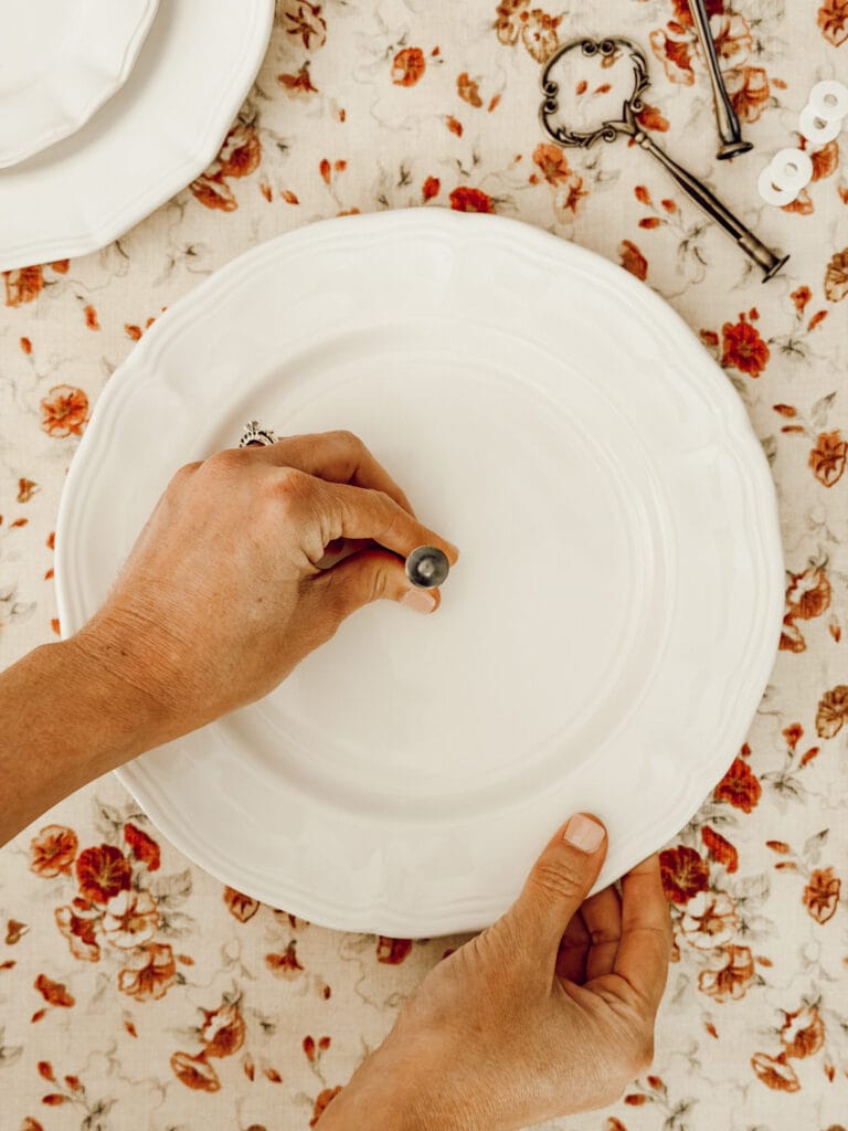 Thread the tiered tray hardware though the dinner plate.