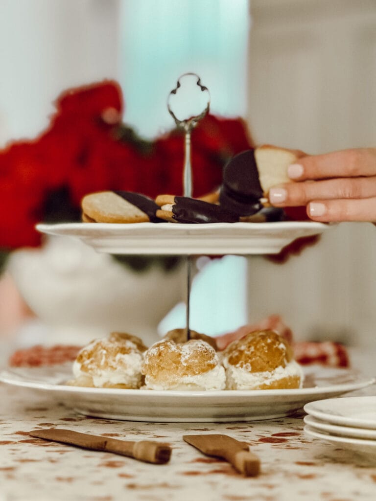 Tiered tray displayed on kitchen counter full of sweet treats for entertaining.