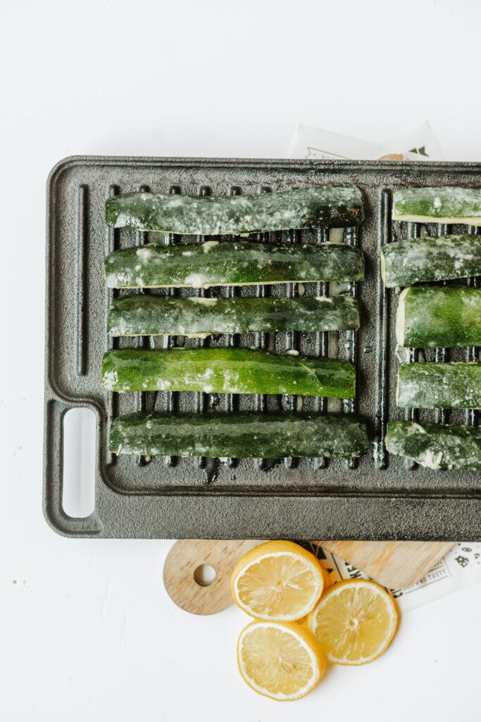 Marinated zucchini spears on a grill pan for a cookout or weeknight dinner.