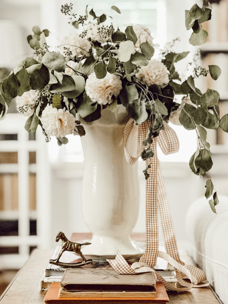 AI home decorating using artificial intelligence. This photo features a vase full of dried and faux flowers.