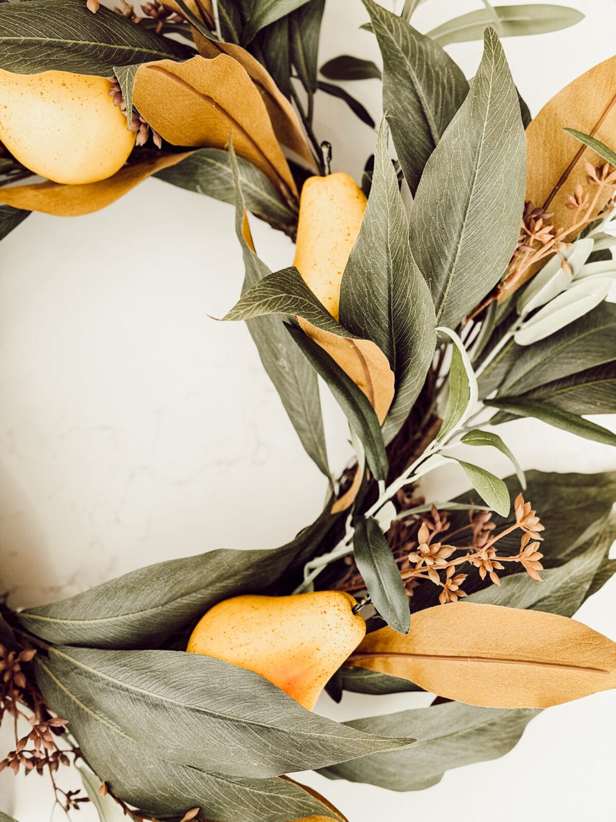 Adding faux pears to a fall for the front door for cozy fall decorating.