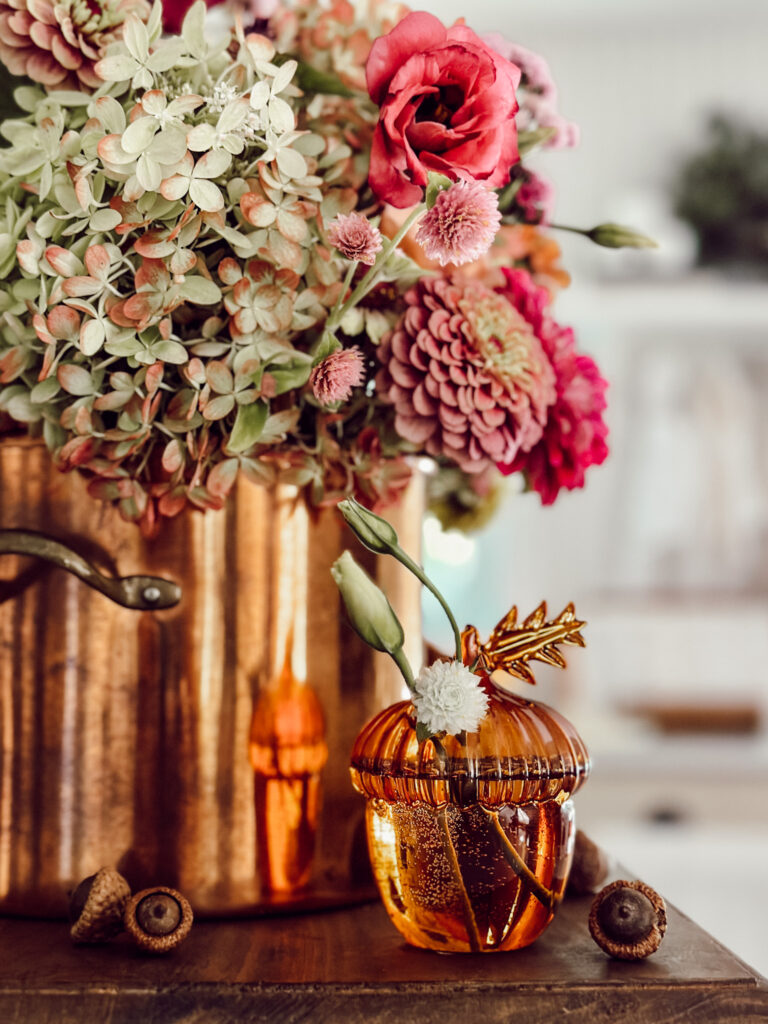 Easy fall floral arrangement with fall colored flowers in a copper pot.