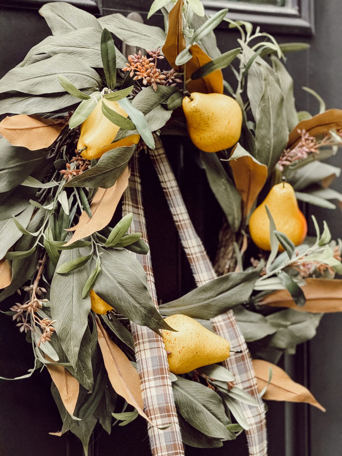 Fall Wreath with pears hanging on our black front door for the fall season.