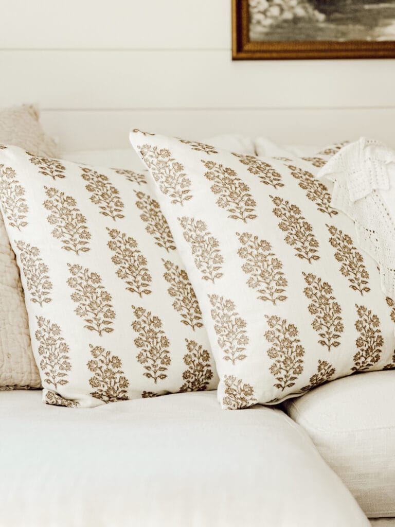 Block print throw pillows on a white couch home decorating ideas with AI.