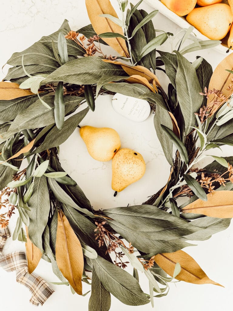 Simple supplies to make a DIY faux pear wreath include a store-bought wreath and faux pears.