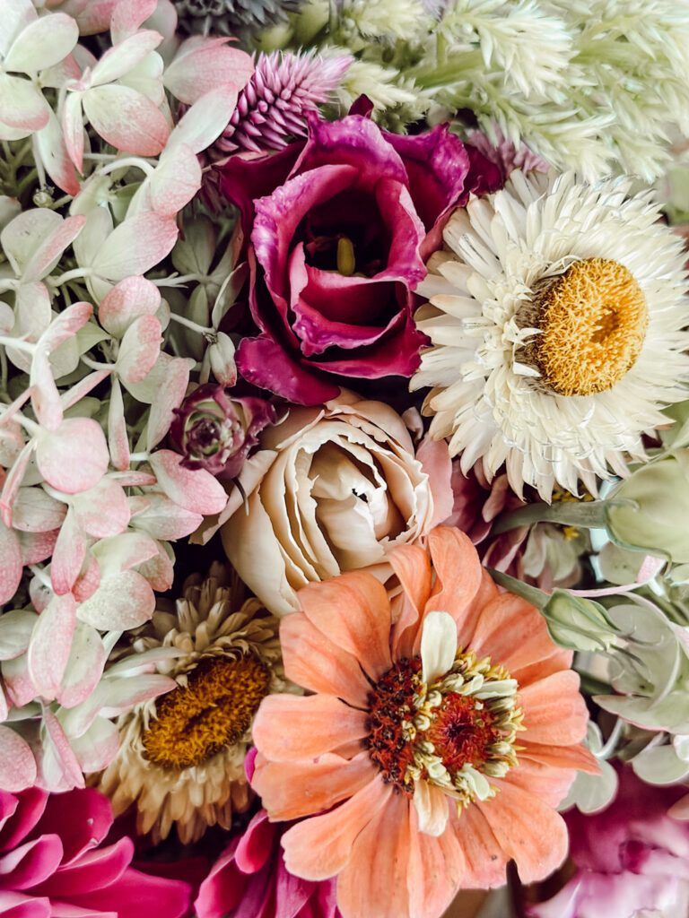 Variety of fall flowers for a unique autumn centerpiece for cozy home decor.
