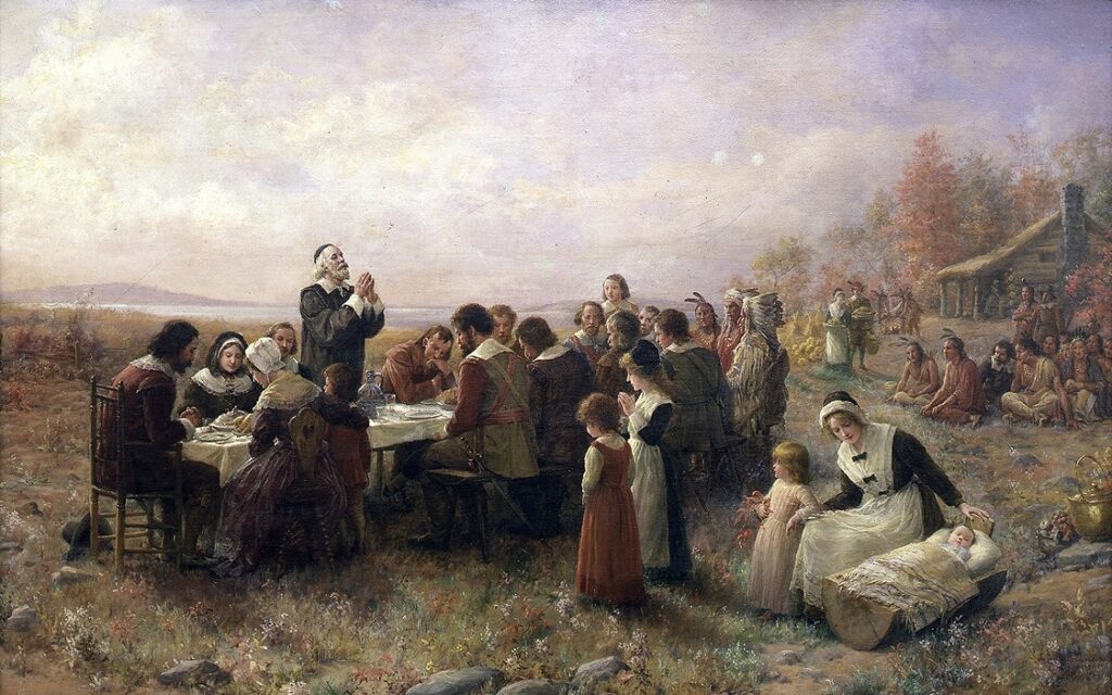 Vintage Thanksgiving painting with pilgrims and Native Americans in Plymouth, Massachusetts.