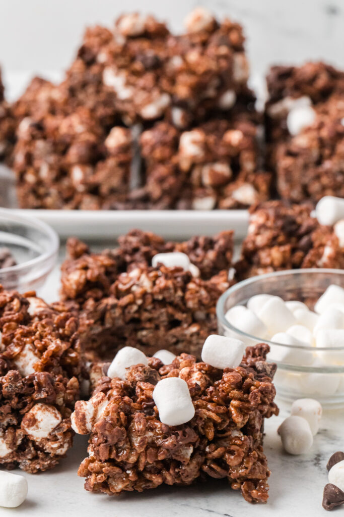 Bars of hot cocoa Rice Krispies treats with mini marshmallows and chocolate chips.