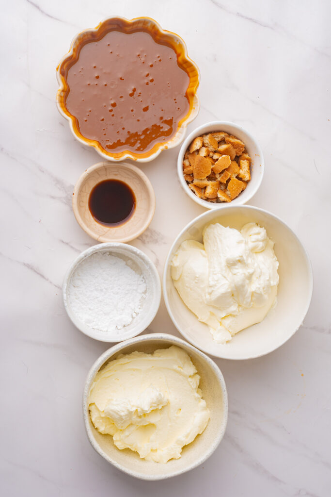 The simple ingredients you'll need to make caramel apple dip include caramel sauce, vanilla extract, powdered sugar, whipping cream, and vanilla wafers.