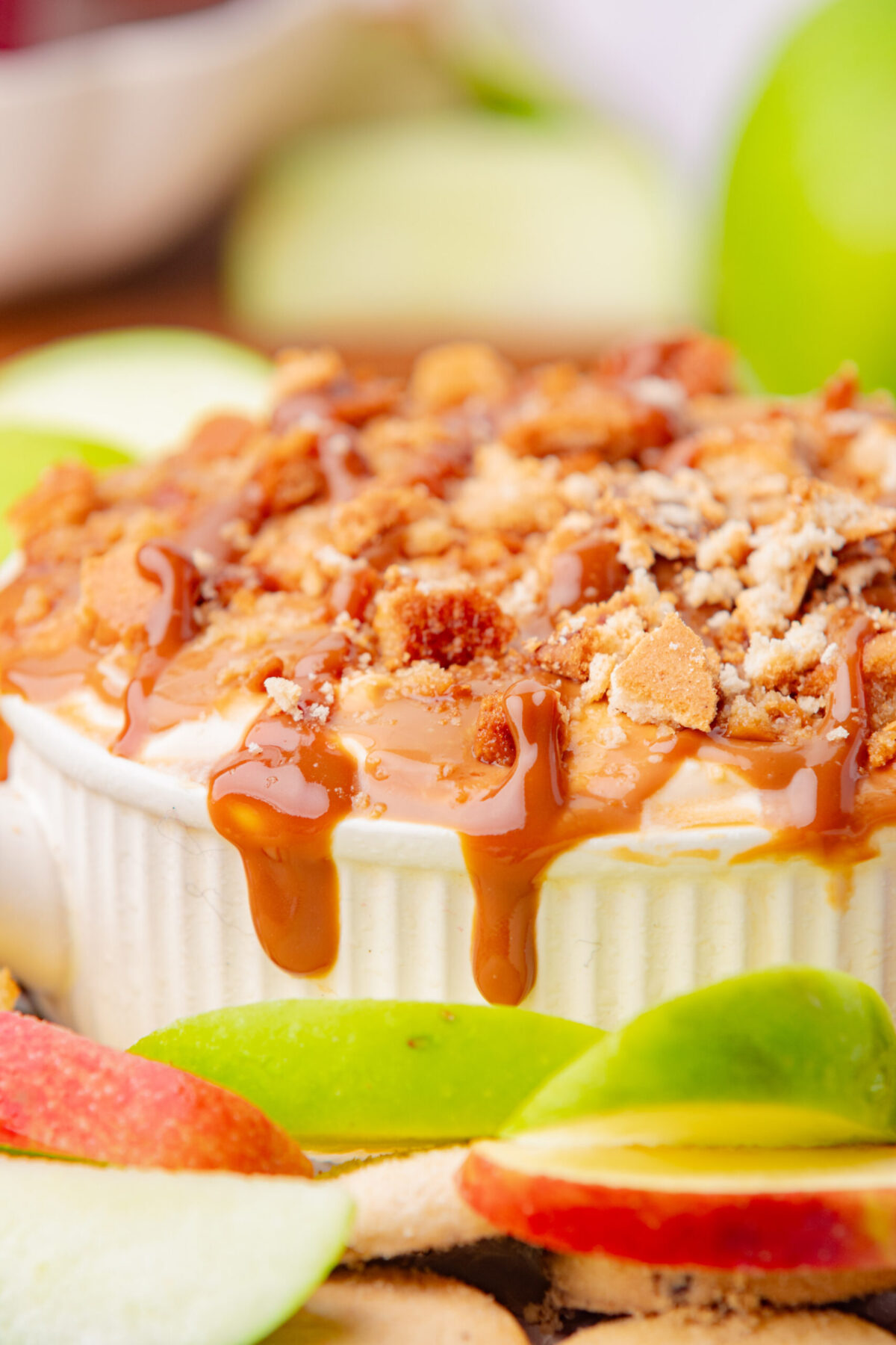 Caramel apple dip with cream cheese and apple slices for dipping.