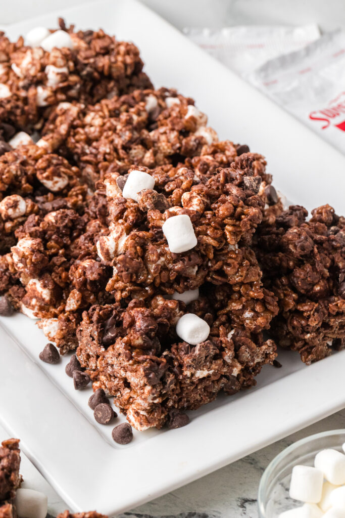 Cocoa cereal treats on a white serving platter.