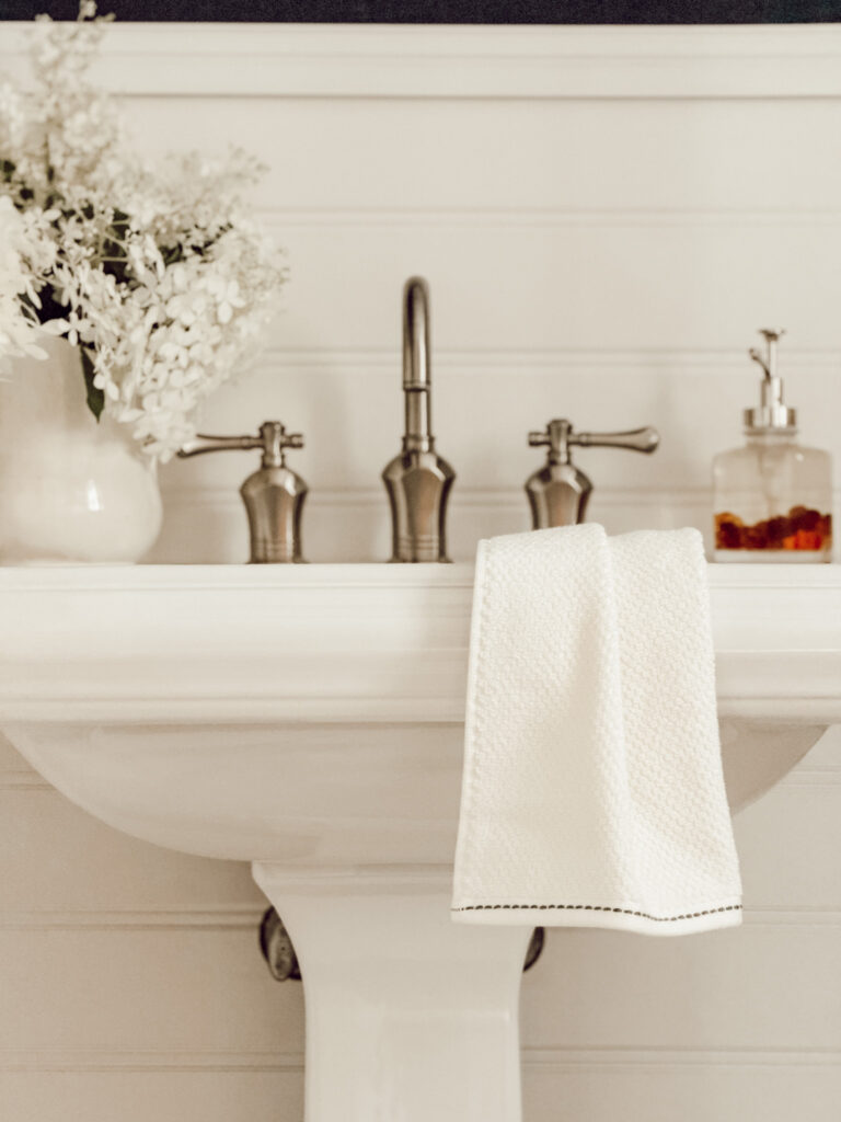 Decorate your bathroom for fall with a DIY fall soap dispenser, towel, and pitcher of fresh hydrangeas.