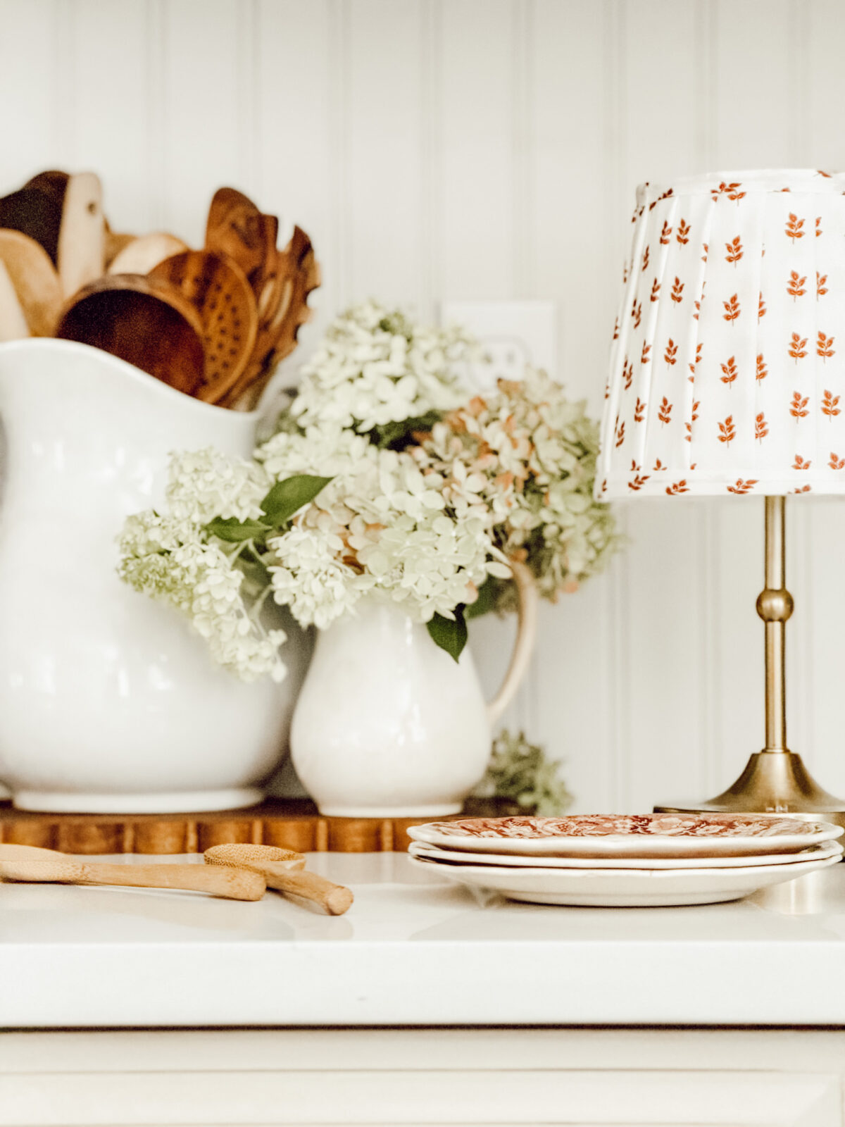 Weekly Wednesday Wish List #271 Eleanor Rose Home kitchen counter with a pitcher of wooden spoons and a creamer full of hydrangeas.
