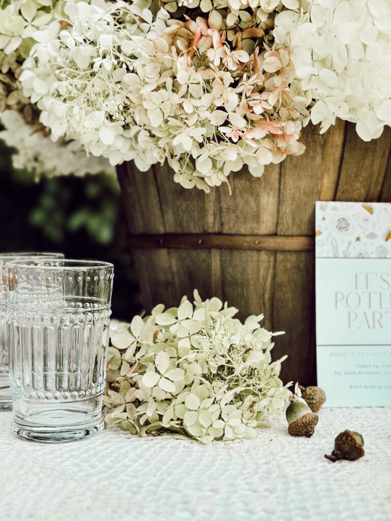 Wooden basket with hydrangea stems inside for cozy home decorating.