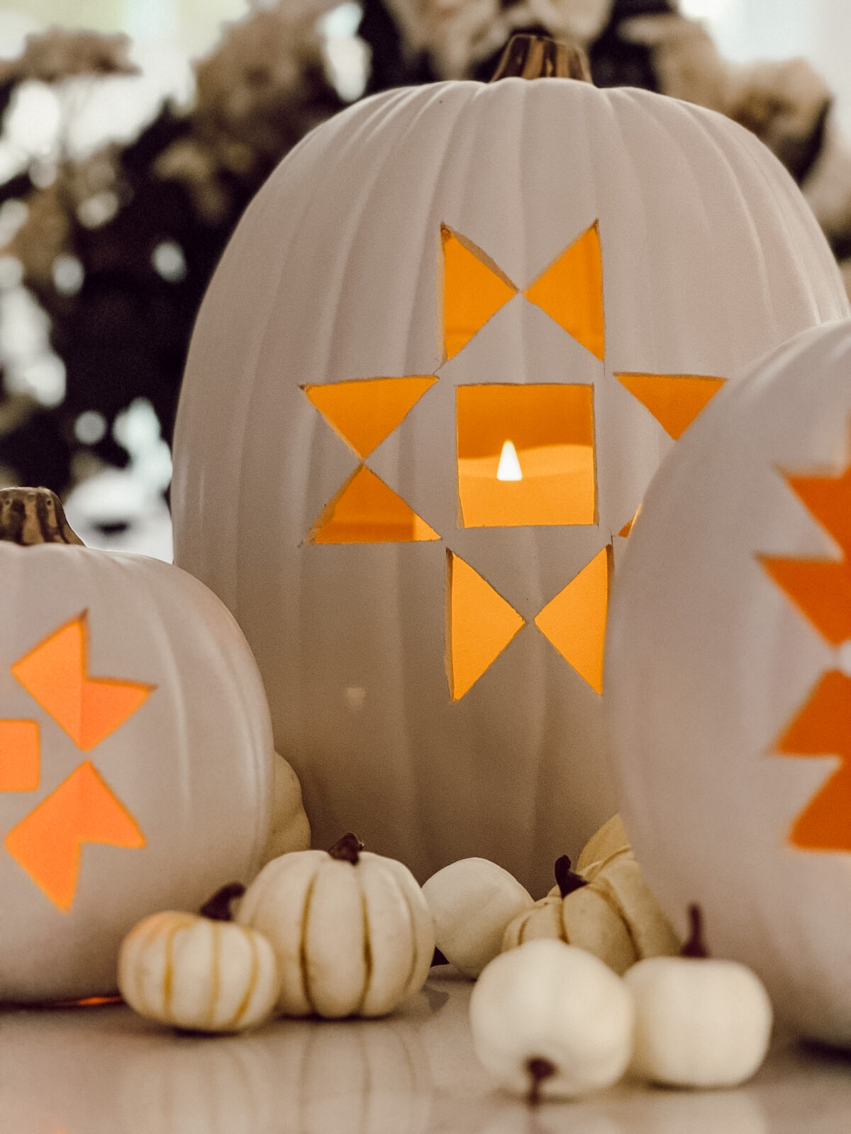 Carved faux pumpkins with quilt design on kitchen counter for easy fall decorating.